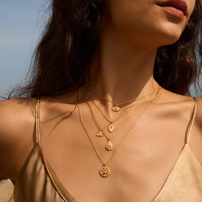 A model showcases layered necklaces including the Shifting Consciousness Snake Necklace, radiating elegance and spirituality. This collection emphasizes meaningful jewelry for meditation, zodiac beliefs, and personal empowerment through protection and manifestation.