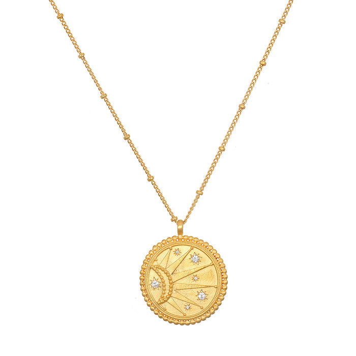 Close-up of the sunburst side of the First Light Gold Medallion Reversible Pendant Necklace, featuring white topaz stars, symbolizing vitality and charm in spiritual jewelry for yoga and protection.
