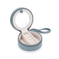 Inside view of the For the Journey Travel Jewelry Case featuring a round mirror, ring holder for 6 rings, and a soft velvet lining. Perfect for storing spiritual jewelry, meditation items, and talismans. Ideal for protecting your meaningful pieces during travel, including mala beads, zodiac-themed accessories, and more.