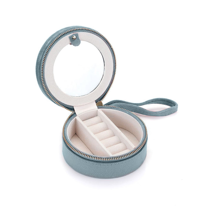 Inside view of the For the Journey Travel Jewelry Case featuring a round mirror, ring holder for 6 rings, and a soft velvet lining. Perfect for storing spiritual jewelry, meditation items, and talismans. Ideal for protecting your meaningful pieces during travel, including mala beads, zodiac-themed accessories, and more.