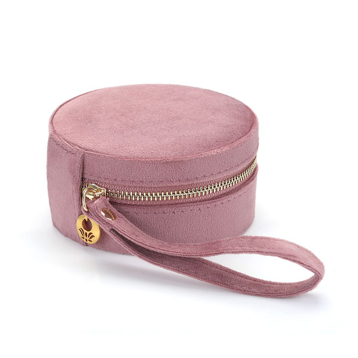 Exterior view of the For the Journey Travel Jewelry Case showcasing its elegant pink velvet texture and golden zipper, perfect for keeping your zodiac and meaningful jewelry safe on your travels.