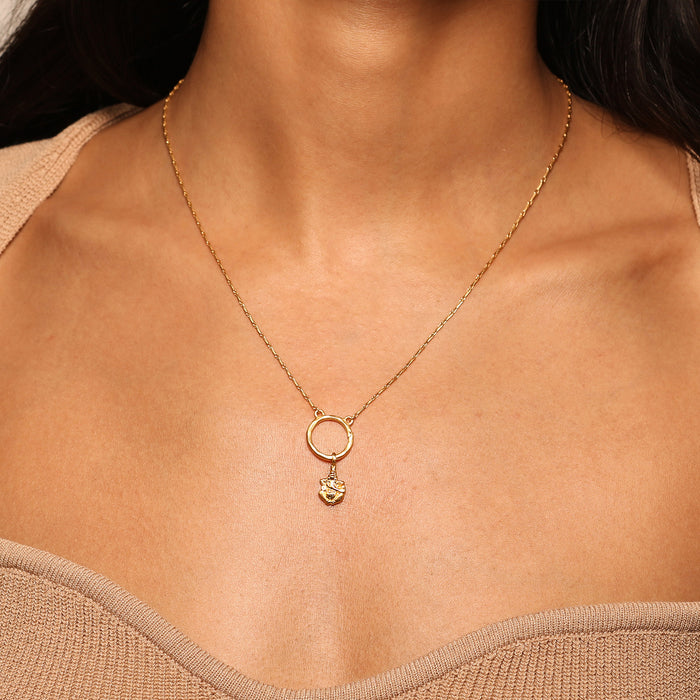 Close-up of a necklace featuring the Ganesha Hindu God Charm styled with a gold circle pendant, representing spiritual connection and personal growth. This elegant piece of spiritual jewelry is a powerful talisman for meditation and protection, perfect for yoga enthusiasts and anyone seeking meaningful manifestation.