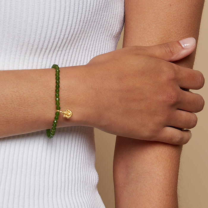Close-up of Ganesha Hindu God, Guided Transformation Jade Gemstone Bracelet worn on a person's wrist, showcasing its spiritual significance and charm. This bracelet embodies spirituality, making it perfect for meditation, zodiac connections, and meaningful manifestations.