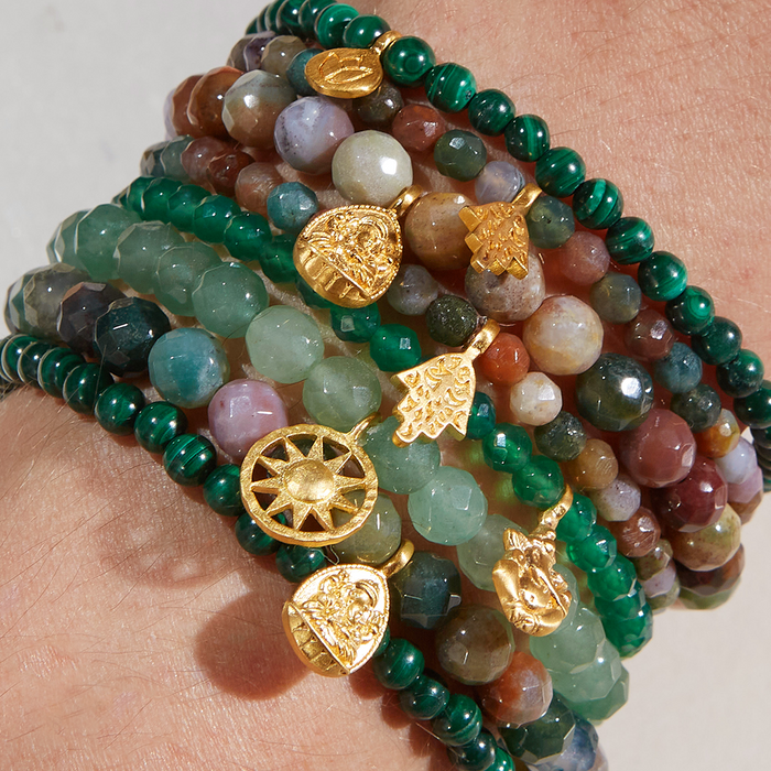 Stacked view of multiple gemstone bracelets including the Ganesha Hindu God, Guided Transformation Jade Gemstone Bracelet, highlighting the vibrant colors and spiritual treasures. This collection symbolizes protection and meaningful connections in yoga and meditation practices.