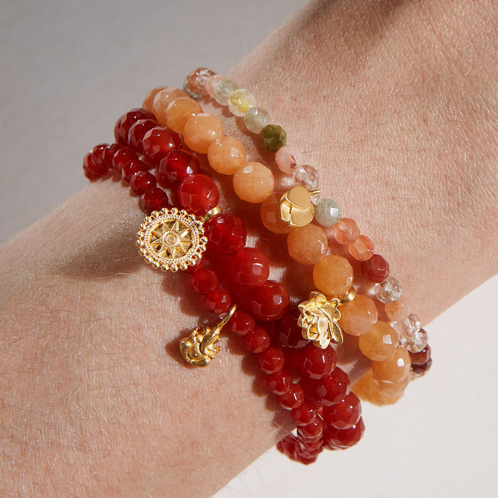 A beautiful collection of Ganesha Hindu God, Overcoming Obstacles Carnelian Gemstone Bracelets stacked together, showcasing vibrant carnelian beads that symbolize confidence and strength. This spiritual jewelry acts as a meaningful talisman for meditation and protection, perfect for yoga and personal manifestation.