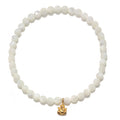 Ganesha Hindu God Pearl Gemstone Bracelet featuring mother of pearl beads and an 18kt gold plate Ganesha pendant. This spiritual jewelry piece serves as a meditation gift, embodying meaningful symbolism and protective qualities, perfect for yoga and mantra practices. Its sacred design is ideal for manifestation and carries deep meaning, making it a thoughtful zodiac amulet.