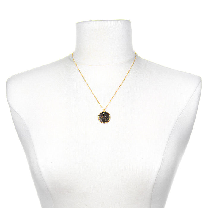 Gemini Zodiac Necklace displayed on a mannequin, highlighting its beautiful gold chain and unique pendant; a perfect representation of zodiac-inspired spiritual jewelry for personal growth and manifestation.