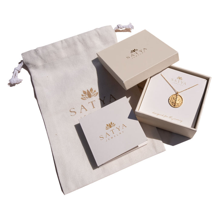 Elegant Gift Box containing spiritual jewelry from Satya, featuring a talisman pendant and a soft pouch, ideal for meditation and yoga practices, symbolizing protection and meaningful manifestation of one's zodiac qualities.
