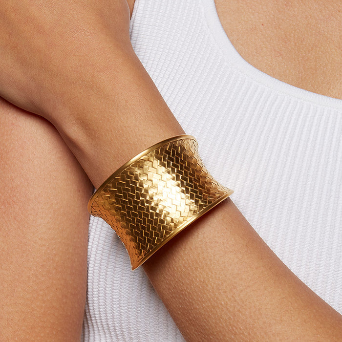 Gold Medium Basketweave Bracelet Cuff worn elegantly on a wrist, showcasing its intricate design. This spiritual jewelry piece is perfect for adding a meaningful touch to any outfit, embodying symbolism and manifestation.