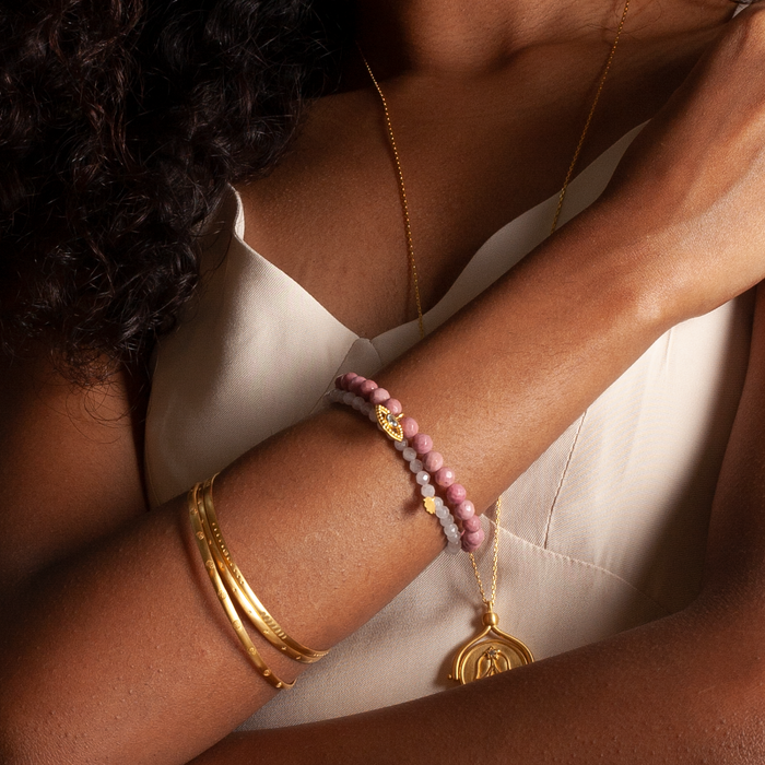 Gold Melody Bracelet Bangle worn on a model's wrist, illustrating its significance as a piece of zodiac-inspired jewelry and a meaningful amulet for modern meditation.