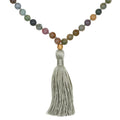 Grounding Fancy Jasper Gemstone Mala featuring 108 smooth round beads, a gold lotus bead, and a hand-tied silk tassel. This spiritual jewelry enhances meditation, serves as a talisman for grounding and focus, and symbolizes new beginnings in the practice of yoga and manifestation.