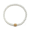 Stretch bracelet with white iridescent round beads and gold-tone moon-shaped accent bead.