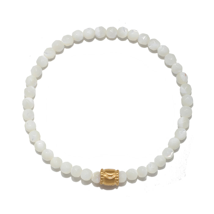 Stretch bracelet with white iridescent round beads and gold-tone moon-shaped accent bead.