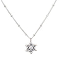 Guiding Faith Silver Star of David Necklace showcased elegantly, featuring a sparkling white topaz at its center. This spiritual jewelry serves as a talisman for protection and meditation, embodying the meaning of faith and connection to the universe. Perfect for yoga practitioners and those seeking meaningful adornments for manifestation.