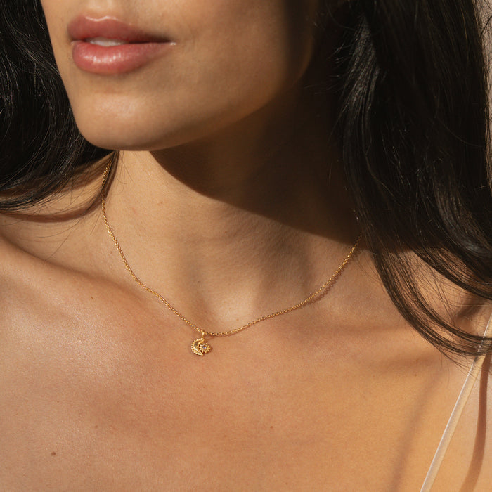 A close-up of a person wearing the Guiding Star Celestial White Topaz Necklace, featuring a charming crescent moon and white topaz stone. This spiritual jewelry piece enhances meditation and empowers manifestation, perfect for those seeking protection and meaningful connections in their zodiac and yoga journey.