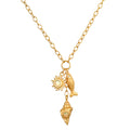 Gold-toned chain necklace with sun charm, fish pendant, and shell charm with pearl-like center stones.