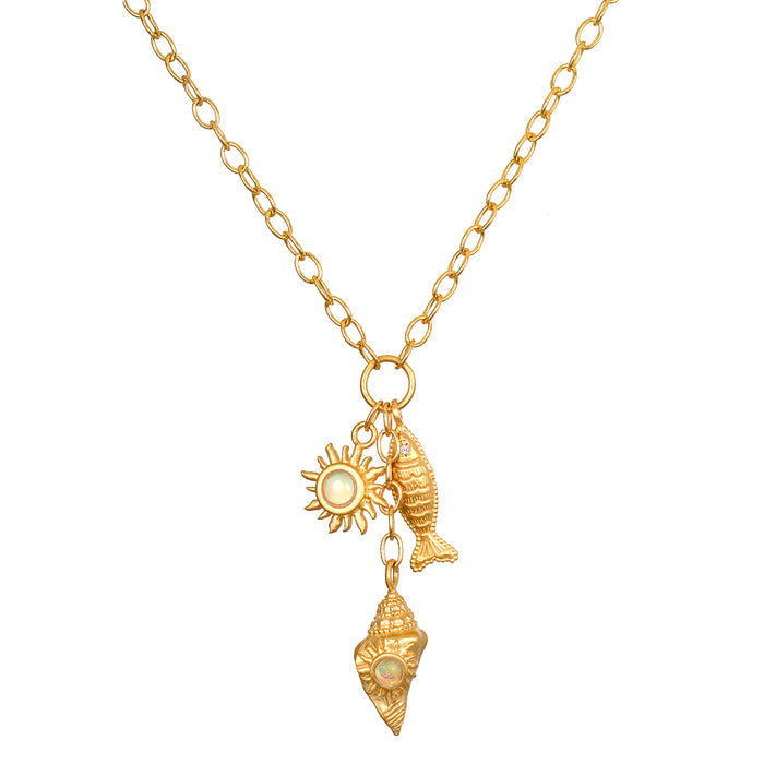 Gold-toned chain necklace with sun charm, fish pendant, and shell charm with pearl-like center stones.