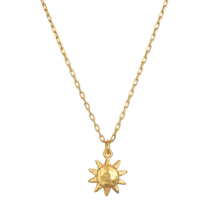 Here Comes the Sun Necklace featuring a hammered 18kt gold plated sun pendant on a delicate chain, embodying the meaning of vitality and leadership. This spiritual jewelry is perfect for meditation and manifestation, resonating with the sun's powerful energy. Ideal for yoga enthusiasts seeking meaningful talismans.