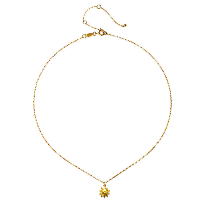 Close-up view of the Here Comes the Sun Necklace featuring a hammered gold sun pendant on a delicate chain, highlighting its significance in spiritual jewelry and yoga accessories. This meaningful talisman symbolizes vitality and connection to the universe.