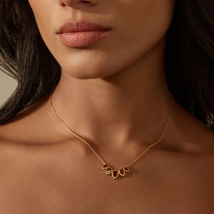Model wearing the Ignite Strength Garnet Petal Necklace, showcasing its elegant design with garnet stones that symbolize strength and new beginnings, a meaningful addition to spiritual practice, yoga, and personal protection.