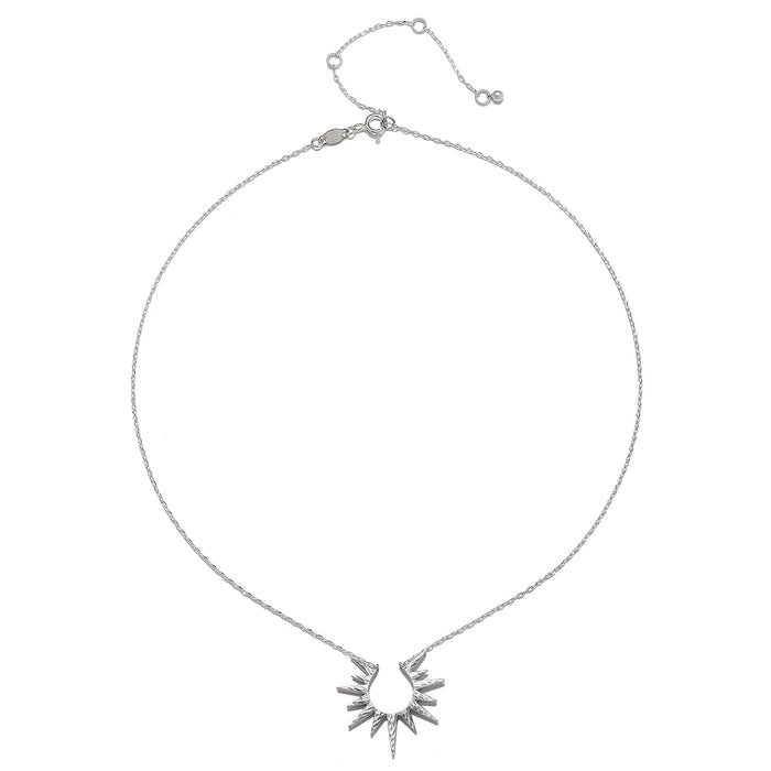 Close-up view of the Incandescent Glow Silver Starburst Necklace on a white background, emphasizing its radiant sterling silver design. This necklace embodies the essence of spiritual jewelry, making it a beautiful charm for those focused on meaning, protection, and manifestation.