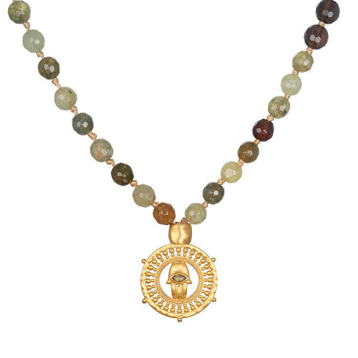 Inhabit Your Power Smokey Quartz Green Garnet Mala featuring 108 smokey quartz and green garnet beads, designed as spiritual jewelry for meditation and as a meaningful talisman. This mala symbolizes protection with its intricate hamsa charm and evil eye made of labradorite, perfect for those practicing yoga and manifestation. Ideal for enhancing spirituality and zodiac connections.
