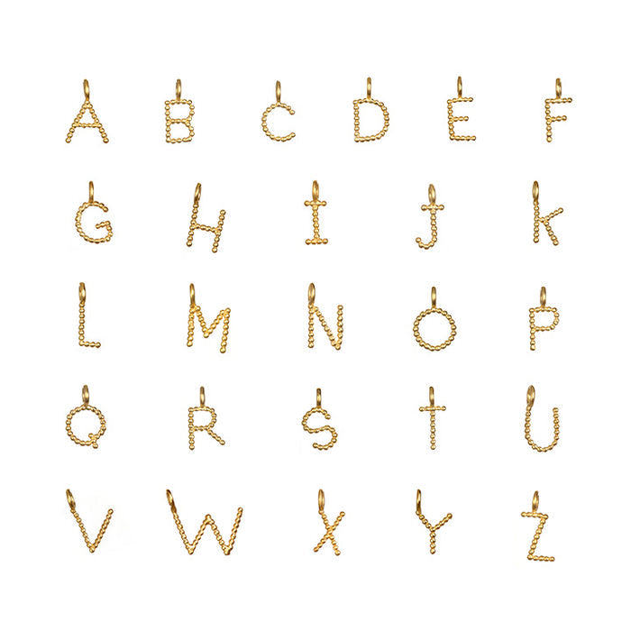 A display of Initial Letter Charms in 18kt gold plating, featuring the complete alphabet, perfect for personalized spiritual jewelry that embodies meaning and protection in meditation and yoga practices.