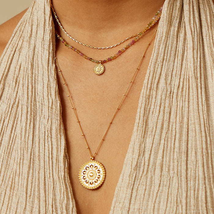 Model wearing the Inner Light Mandala Necklace layered with other necklaces, showcasing its charm and significance in spiritual practices such as meditation and zodiac rituals, contributing to a beautiful and meaningful look.