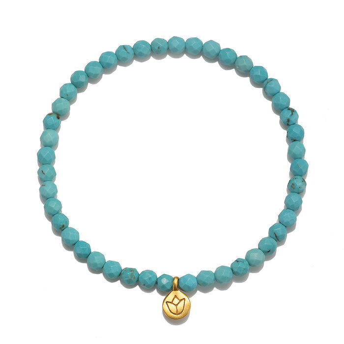 Inner Voice Lotus Gemstone Bracelet featuring turquoise beads and a golden lotus charm, symbolizing new beginnings and health. A perfect piece of spiritual jewelry for meditation, with meaning and charm for manifestation.