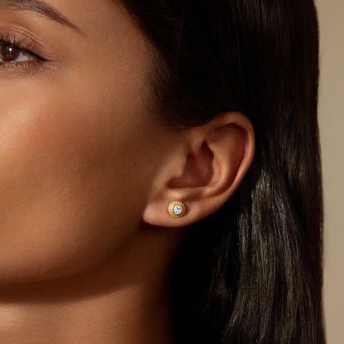 A model wearing Insightful Spirit White Topaz Stud Earrings, highlighting the elegant round white topaz that brings clarity and intention, ideal for individuals interested in spiritual, zodiac, and yoga themes.