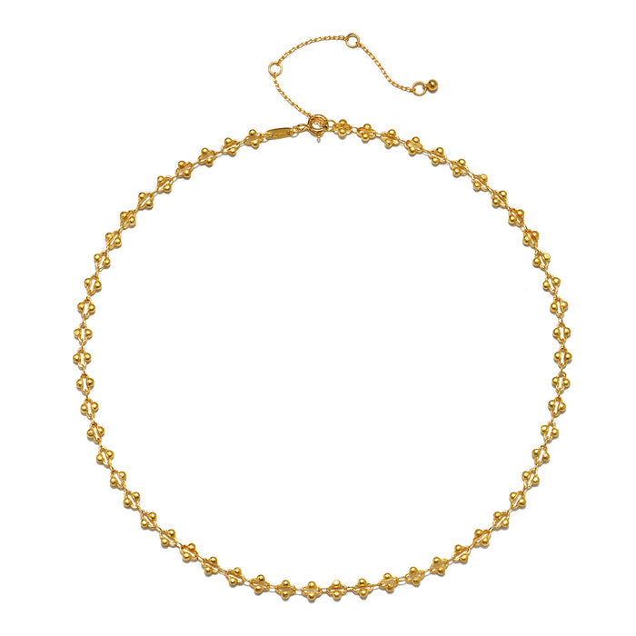 The Golden Hour Coin Chain Necklace displayed on a white background, highlighting its intricate link design and elegant gold finish. This spiritual jewelry item resonates with the concepts of meaning and manifestation, making it a great addition to any zodiac-themed collection or meditation practice.