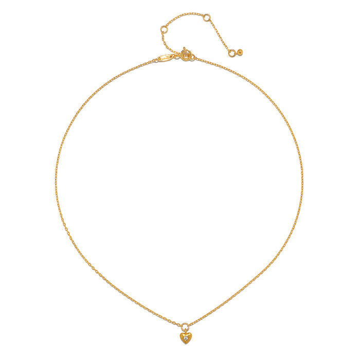 Close-up of the Boundless Love Mini Heart Pendant Necklace displaying its intricate design and gold plating, perfect for spiritual meditation and as a talisman for those seeking individuality and creativity.