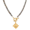 Labradorite bead necklace with gold-tone toggle clasp and circular mandala pendant featuring crystal center.