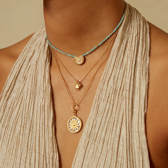 Layered necklaces featuring the Inward Journey Pearl Mandala Necklace alongside other delicate pieces, embodying the essence of spiritual jewelry and charm, designed for meditation and connection to zodiac energies. A perfect combination for yoga enthusiasts and those seeking meaningful adornments.