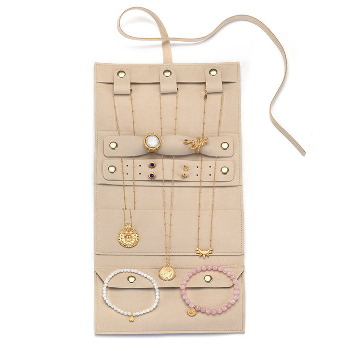 Inside view of the Journey Abroad Travel Wrap showcasing organized jewelry storage. This travel accessory from Satya Jewelry features multiple loops for necklaces and bracelets, perfect for spiritual adornments. Ideal for manifestation and protection, it keeps your meaningful talismans secure while reflecting the essence of the sun and moon.