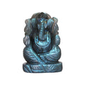 A small statue of the Hindu deity Ganesha carved from labradorite stone with a blue tint.