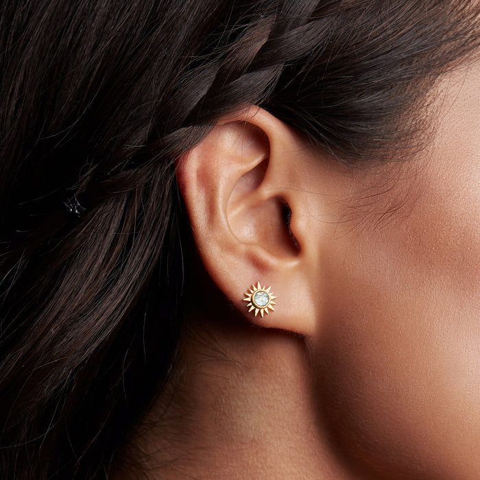 Close-up of a model wearing Light Seeker Blue Topaz Starburst Earrings, highlighting their elegant design and radiant blue topaz. This spiritual jewelry piece serves as a powerful talisman, enhancing communication and wisdom during meditation, making it perfect for yoga and zodiac enthusiasts.
