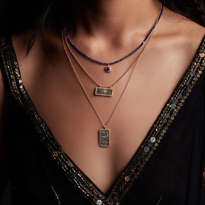 Model wearing the Light Seeker Lapis Starburst Choker Necklace layered with other spiritual jewelry, showcasing a harmonious blend of styles. This necklace acts as a talisman of protection and charm, perfect for yoga and meditation routines.