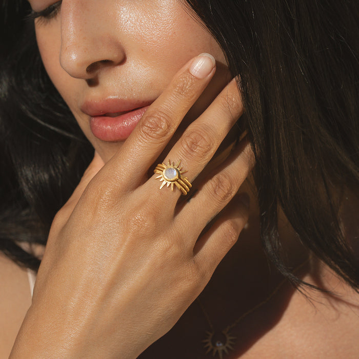 A model wearing the Light Seeker Moonstone Starburst Nested Ring Set, highlighting the elegant gold rings featuring moonstone, embodying spiritual meaning, ideal for yoga practitioners and those drawn to talismans and zodiac energies.