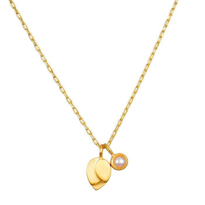 Gold chain necklace with lotus-shaped pendant and pearl charm in gold setting.
