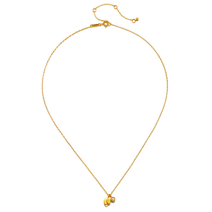 Gold chain necklace with lotus and pearl pendant charms at the bottom and adjustable clasp closure.