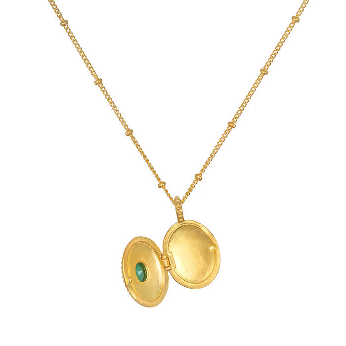 Open view of the Lotus Emerald Birthstone Locket Necklace - May, showcasing its elegant design and the beautiful emerald inside. This necklace serves as a protective talisman for personal keepsakes, bringing together elements of yoga, spirituality, and charm for those who celebrate their birth month and seek abundance in life.