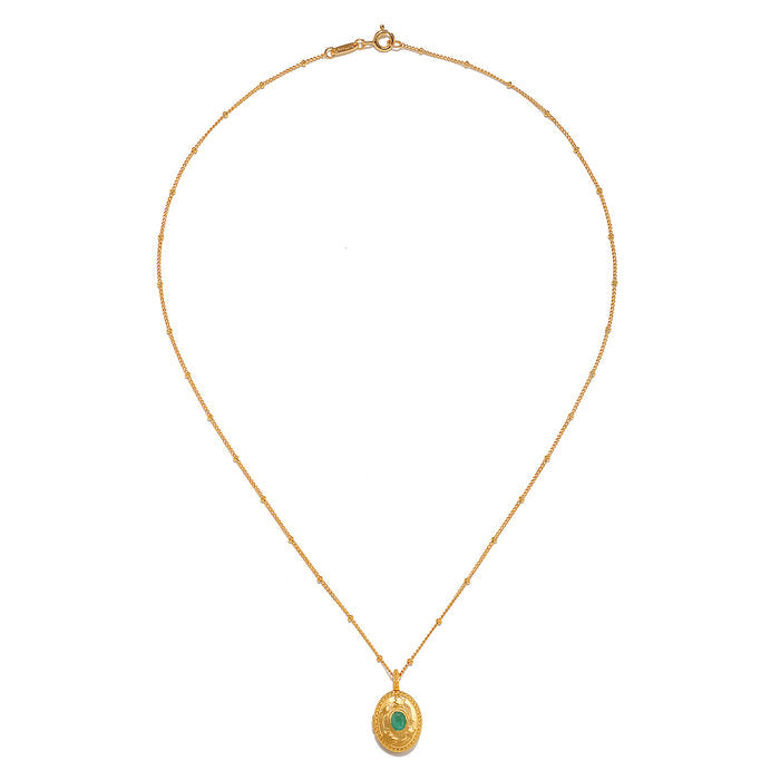 The Lotus Emerald Birthstone Locket Necklace - May displayed elegantly, highlighting its intricate design and the emerald stone. This spiritual jewelry piece is perfect for those who connect with their zodiac traits and appreciate the meaning behind meditation and manifestation, while also adding a touch of charm to their ensemble.