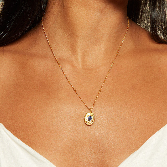 A model wearing the Lotus Sapphire Birthstone Locket Necklace - September, showcasing the locket's design around their neck. This piece of spiritual jewelry symbolizes new beginnings and infinite potential, ideal for meditation and meaningful connections, providing protection and charm.