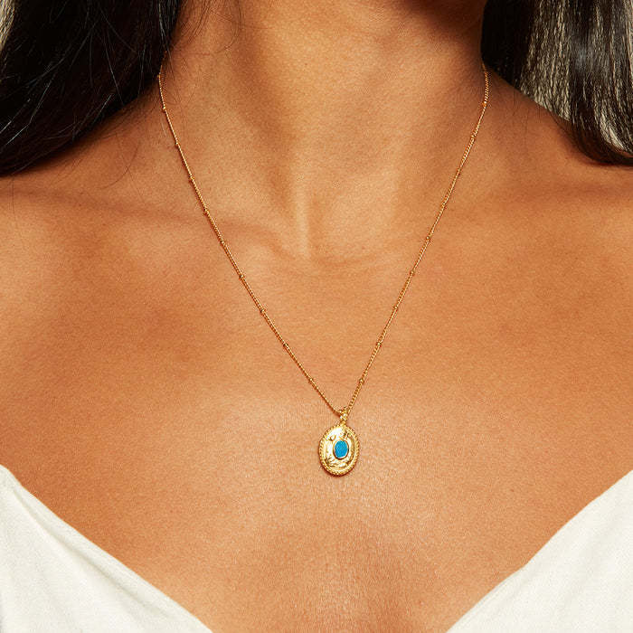 Model wearing the Lotus Turquoise Birthstone Locket Necklace - December, exuding elegance and radiance. This spiritual jewelry piece reflects the essence of yoga and meaningful connections, making it a perfect charm for spiritual growth.