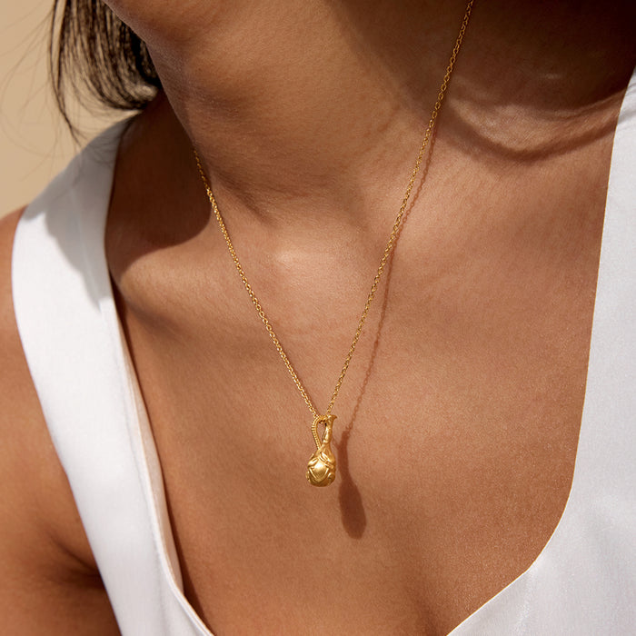 Model wearing the Love Potion Lotus Vessel Necklace, showcasing its elegant design on a delicate chain, symbolizing new beginnings. This spiritual jewelry piece serves as a talisman for protection and meaningful meditation, ideal for those interested in zodiac elements and holistic wellness.