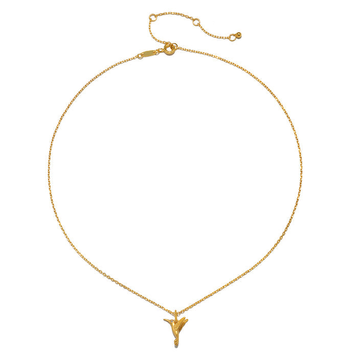 The Loving Devotion Hummingbird Necklace displayed elegantly, illustrating its 18kt gold plate design. This spiritual jewelry piece acts as a talisman, reflecting themes of protection, meditation, and meaningful connections in the journey of life.