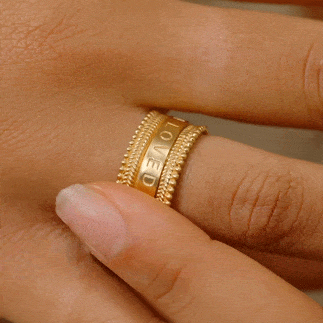Close-up of the Loving Mantra Spinning Ring worn on a finger, illustrating its charm and connection to spirituality and protection, ideal for yoga and meditation practices.