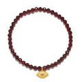 Loving Protection Garnet Evil Eye Bracelet featuring faceted red garnet beads and an 18kt gold plate evil eye charm, symbolizing protection and intuition. This spiritual jewelry is perfect for meditation and manifestation, connecting with the universe through its meaningful design. Ideal for yoga practitioners and those interested in zodiac and talismans.