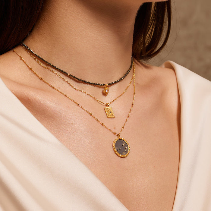 Model showcasing the Magic in Moonlight Necklace layered with other necklaces, emphasizing its celestial charm and suitability as spiritual jewelry for those interested in zodiac meanings and talismans.
